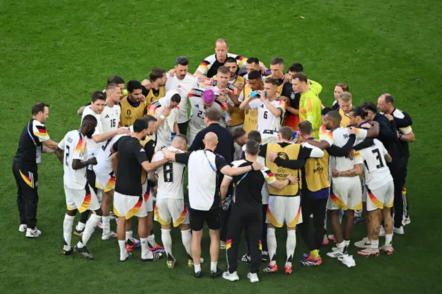 German team have a team talk in a huddle