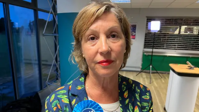 a woman with a blue rosette