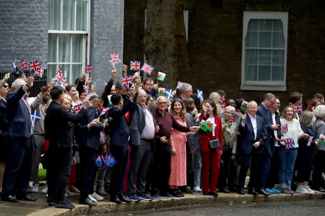 People wave in Downing Street