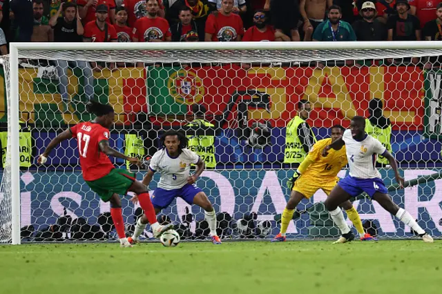 Rafael Leao (L) kicks the ball