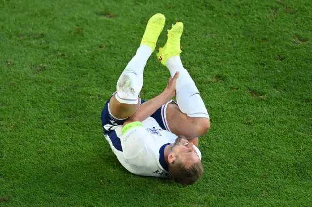 Harry Kane holds his leg