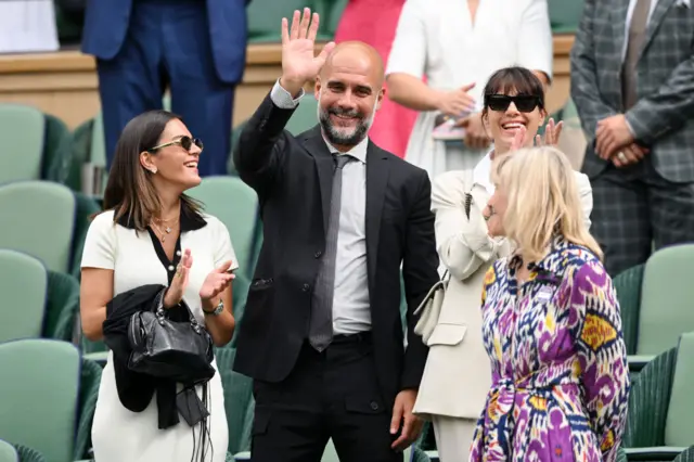 Pep Guardiola waves to Alexander Zverev