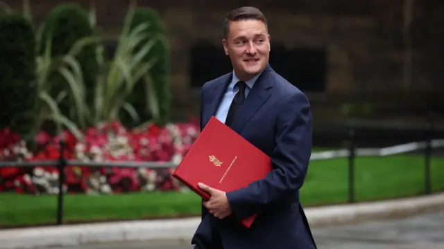 Wes Streeting looks behind him as he walks along Donwing Street