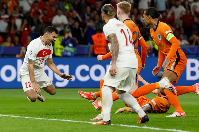 Kaan Ayhan goes down following a challenge by Netherlands' forward Wout Weghorst