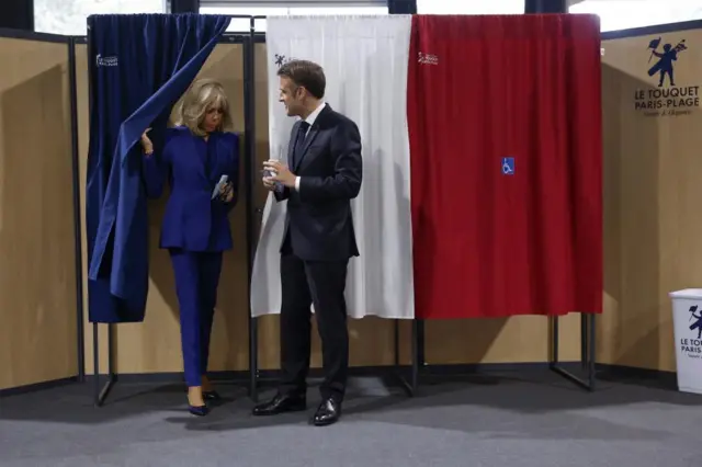 French President Emmanuel Macron (R) and French First Lady Brigitte Macron (L) vote at a polling station in the second round of French parliamentary elections in Le Touquet-Paris-Plage, France, 07 July 2024