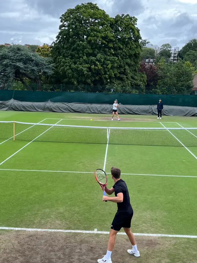 Emma Raducanu practising with Liam Broady