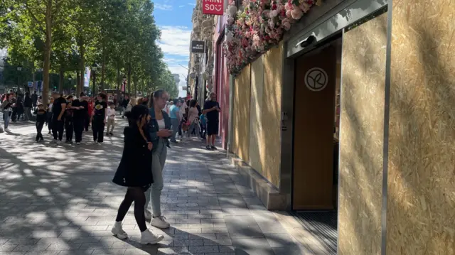 Banks and shops on the Champs-Élysées have been boarded up