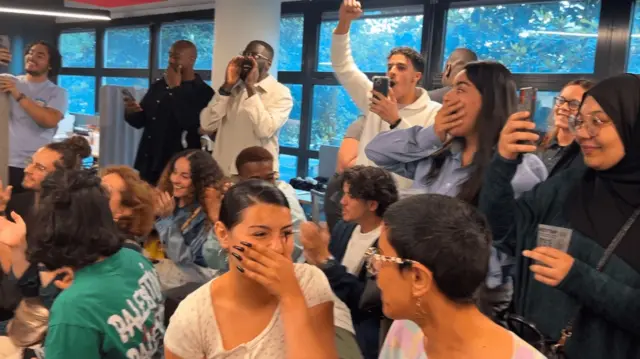 A crowd of young people cheering