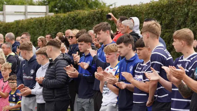 Young fans clap as the cars travel through Featherstone