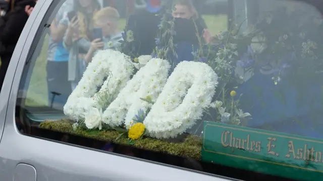 Flowers spelling "Dad" in funeral car