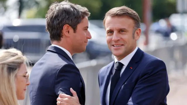Gabriel Attal (L) with Emmanuel Macron