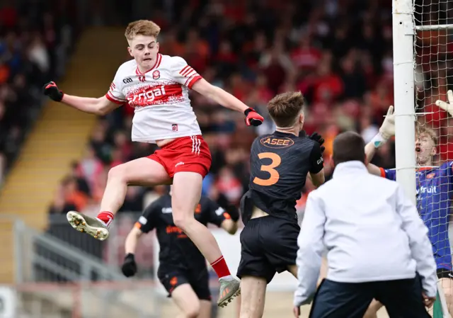 Derry's Cody Rocks palms into the Orchard net at Healy Park