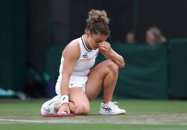 Jasmine Paolini crouches to the ground
