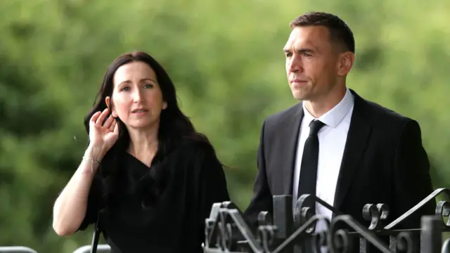Best friend Kevin Sinfield arrives with his wife Jayne at Pontefract Crematorium