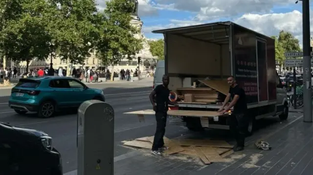 Workers prepare for possible trouble on the Place de la République