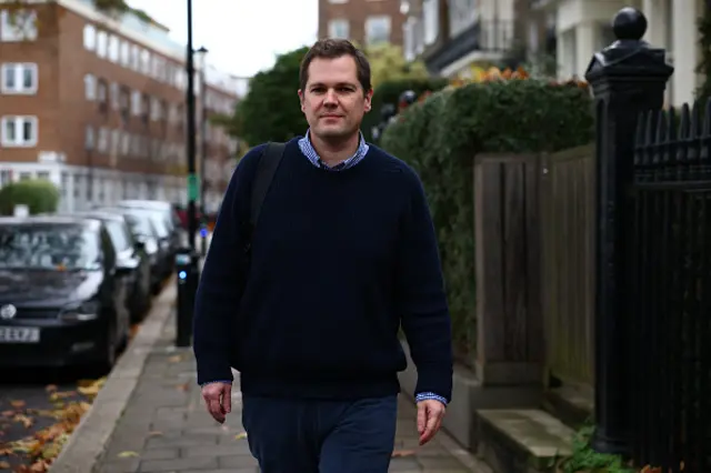 Robert Jenrick walks down a street in central London after resigning from government in December 2023