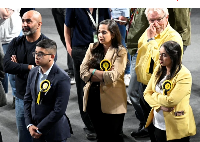 Scottish National Party (SNP) members look on as the counting of votes continues, during the UK election in Glasgow,