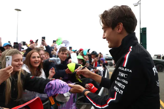 George Russell signs autographs