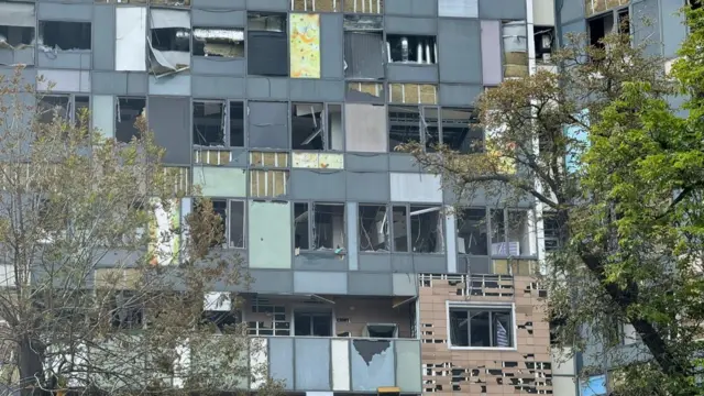 Damaged hospital is seen from outside with windows blown out