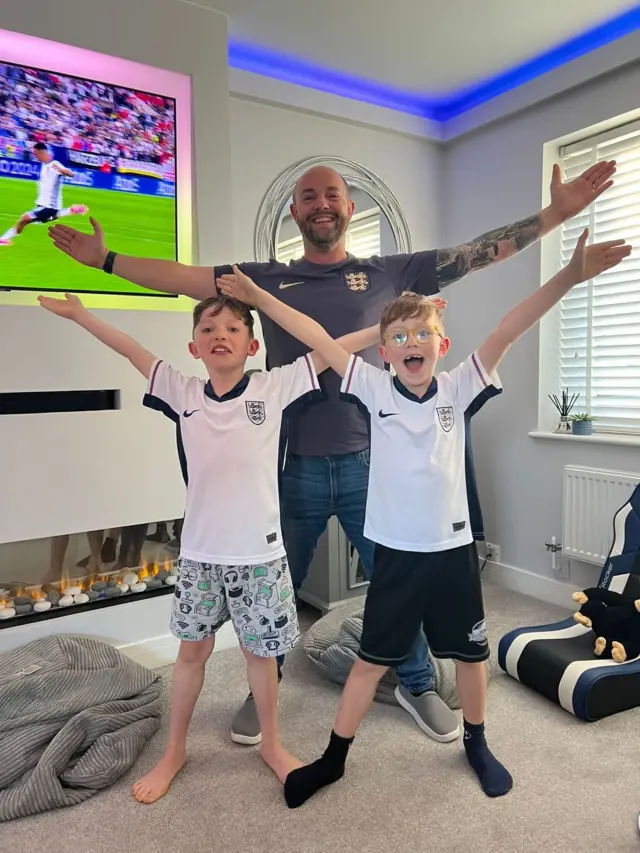 The Davis family in Cricklade, Wiltshire celebrate with the Jude Bellingham pose, arms outstretched