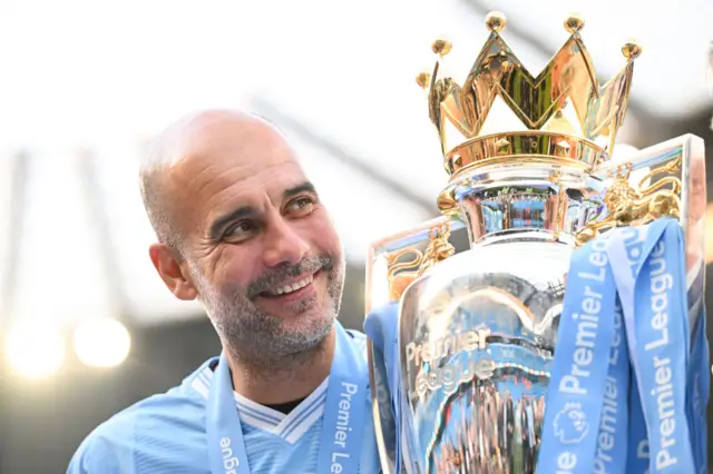 Pep Guardiola with the Premier League trophy