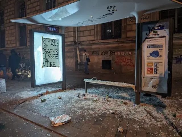 A bus shelter smashed by rioters