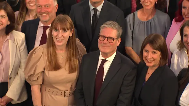 The prime minister smiled while posing for the group photo alongside Chancellor Rachel Reeves and Deputy PM Angela Rayner