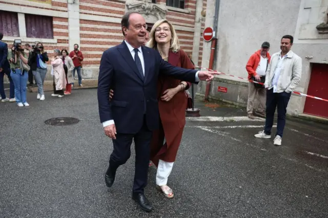 rançois Hollande, former French President and candidate for the left-wing political alliance and his wife Julie Gayet leave a polling station after voting in the first round of the early French parliamentary elections, in Tulle