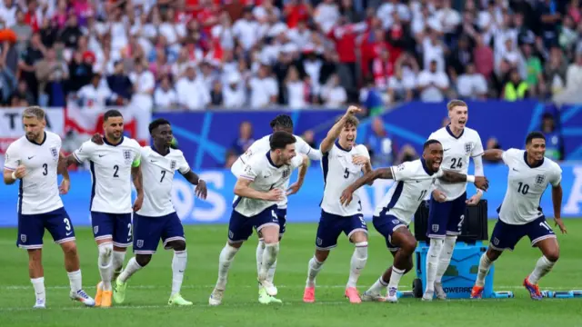 Players of England celebrates following the team's victory in the penalty shoot out after Trent Alexander-Arnold of England (not pictured) scores the team's fifth and winning penalty in the penalty shoot out during the UEFA EURO 2024 quarter-final match between England and Switzerland at Düsseldorf Arena on July 06, 2024 in Dusseldorf, Germany.