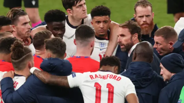 Gareth Southgate, Head Coach of England speaks with his players including Bukayo Saka, Jadon Sancho, Marcus Rashford before the penalty shootout during the UEFA Euro 2020 Championship Final between Italy and England at Wembley Stadium on July 11, 2021 in London, United Kingdom.