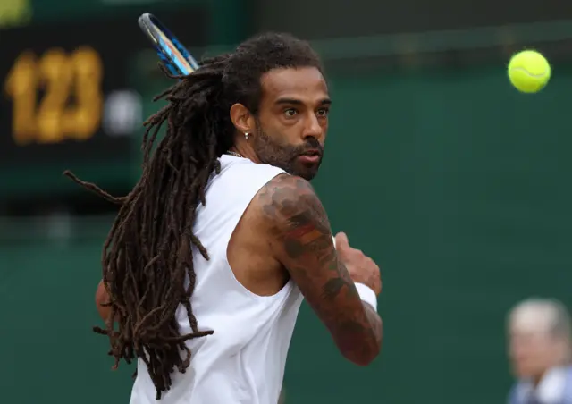 Dustin Brown hits a backhand shot wearing an all-white vest