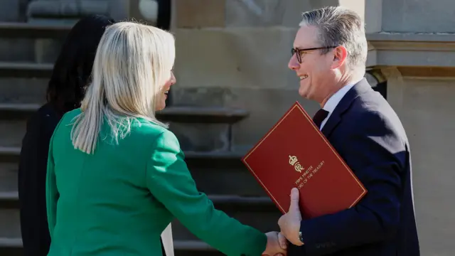 British Prime Minister Keir Starmer shakes hands with First Minister of Northern Ireland Michelle O'Neill at Stormont Castle