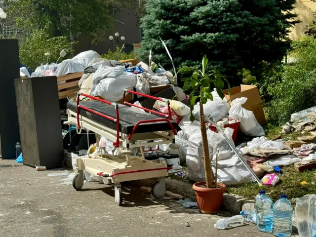 Hospital beds and potted plants amongst the debris that rescue workers are pulling from the hospital.