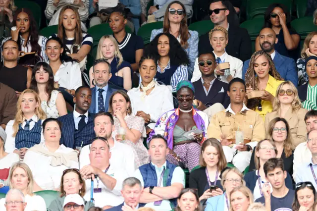 Host of celebrities sitting near each other at Wimbledon