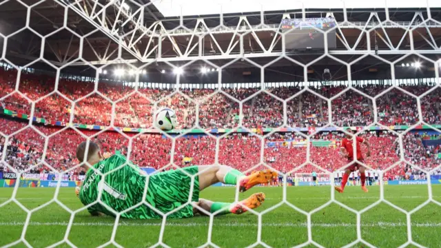 A general view as Jordan Pickford of England saves the first penalty from Manuel Akanji of Switzerland in the penalty shoot out during the UEFA EURO 2024 quarter-final match between England and Switzerland at Düsseldorf Arena on July 06, 2024 in Dusseldorf, Germany