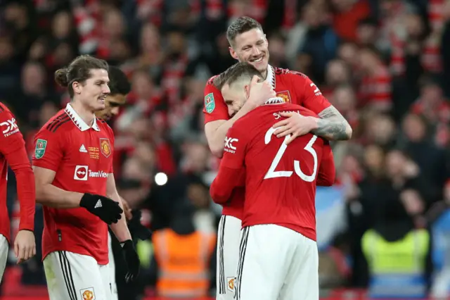 Wout Weghorst hugs Luke Shaw