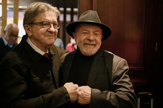 French leftist movement La France Insoumise (LFI)'s presidential candidate Jean-Luc Melenchon (L) salutes Brazil's ex-president Luiz Inacio Lula da Silva (R) before their meeting in a Paris hotel on November 17, 2021.