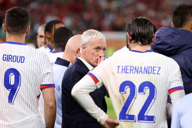 Didier Deschamps, Head Coach of France, speaks with Theo Hernandez