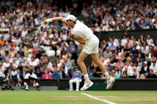 Jannik Sinner serves