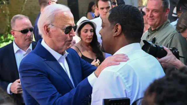 Biden speaks to a man at a campaign event on 7 July