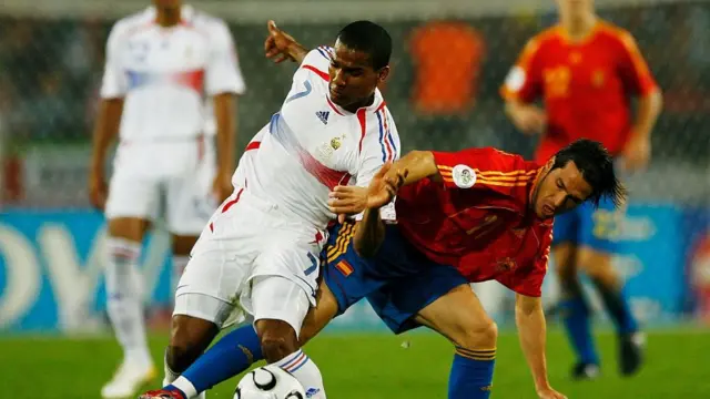 Florent Malouda of France battles for the ball with Luis Garcia of Spain