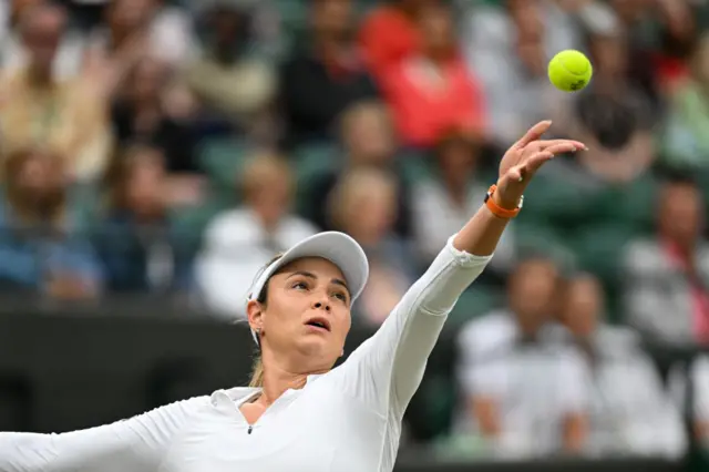 Donna Vekic tosses the ball to serve