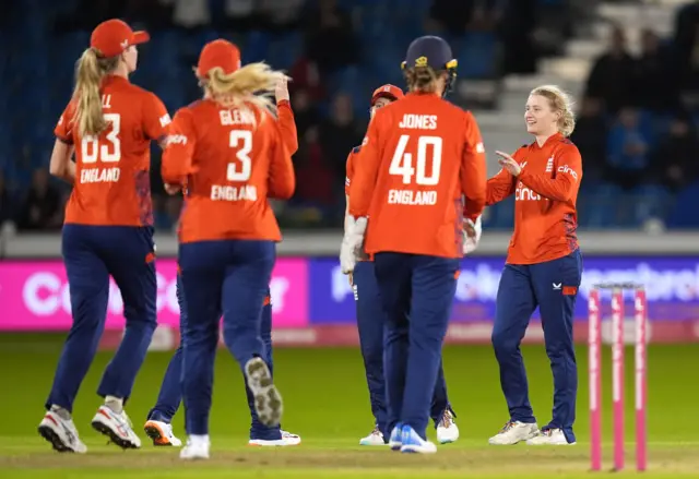 Charlie Dean celebrates the wicket of Brooke Halliday