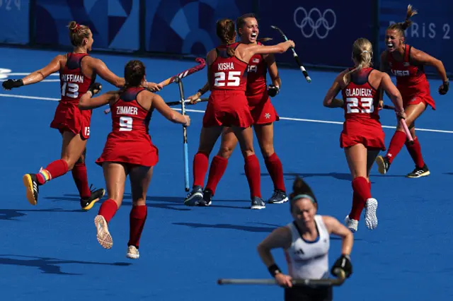 US' players celebrate scoring their first goal in the women's pool B field hockey