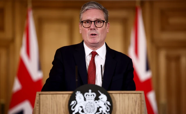 Keir Starmer speaks at lectern during the news conference