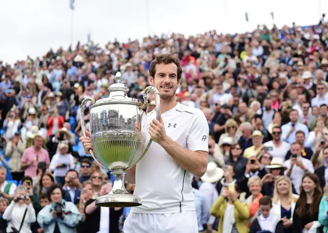 Andy Murray of Great Britain poses with his trophy after winning final match against Milos Raonic