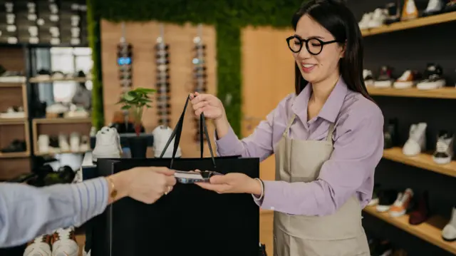 Shop assistant in shoe store