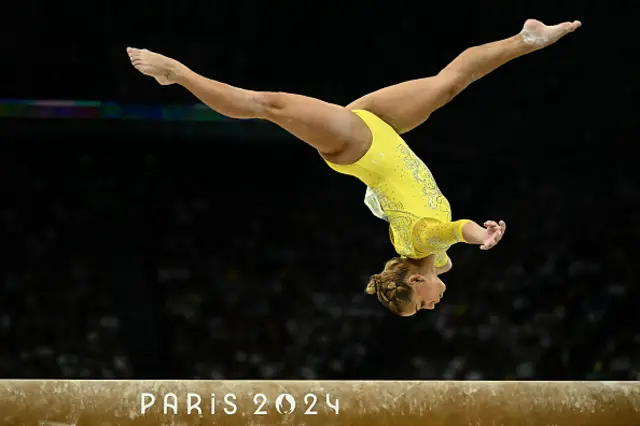 Flavia Saraiva competes in the balance beam