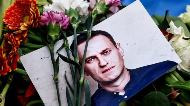 A picture of Alexei Navalny is seen at a memorial after his death