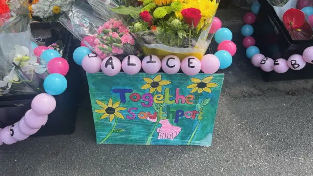 A tribute left at the scene reads "Together Southport"